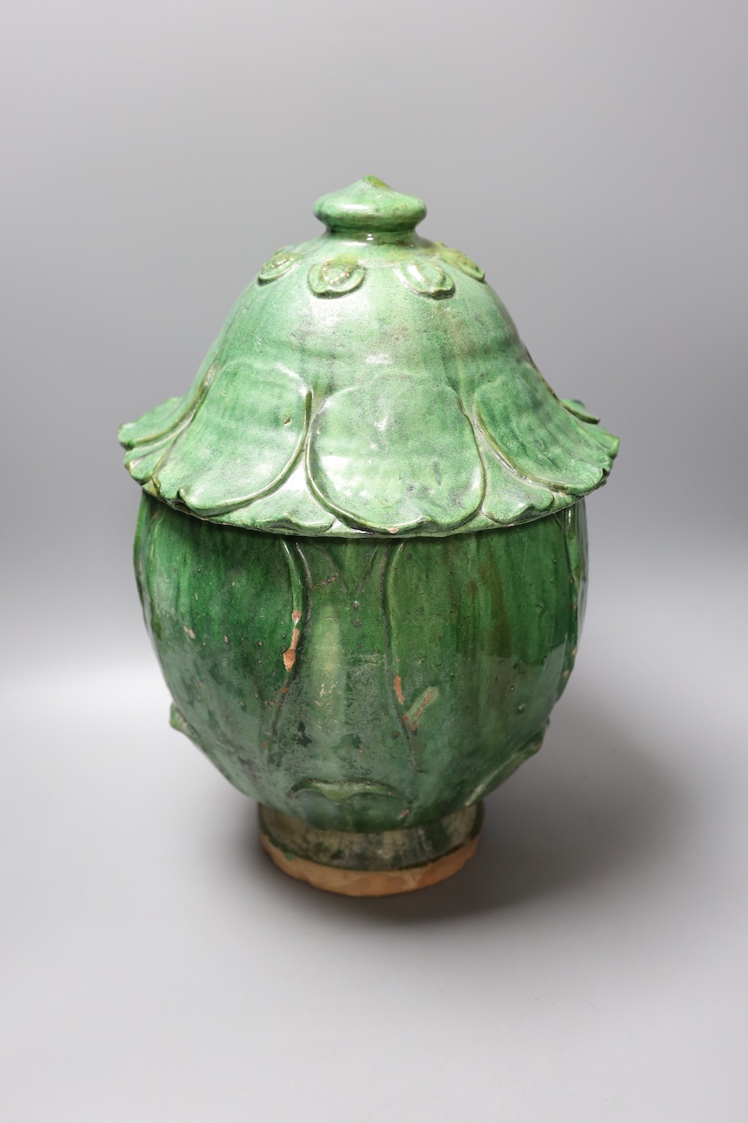 A Buddhist green glazed pottery jar and cover, 10th - 13th century. Thermoluminescence analysis report included, 43cm